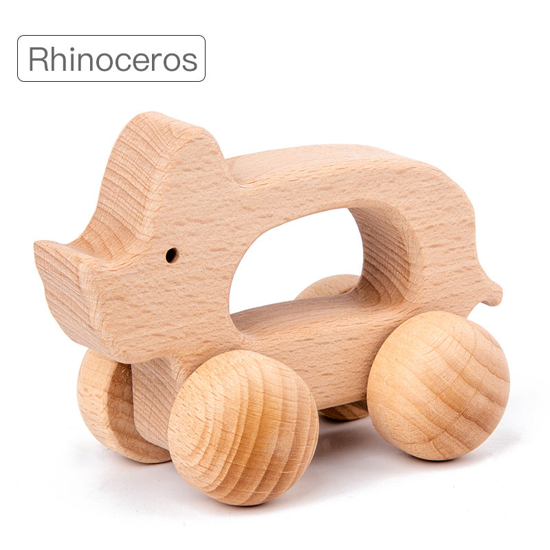 rhino rolling animal toy with natural wood and large round wheels. opening in center of toy for gripping