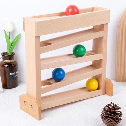 Frontal view of ball tracker with red, green, blue and yellow balls on natural wood track