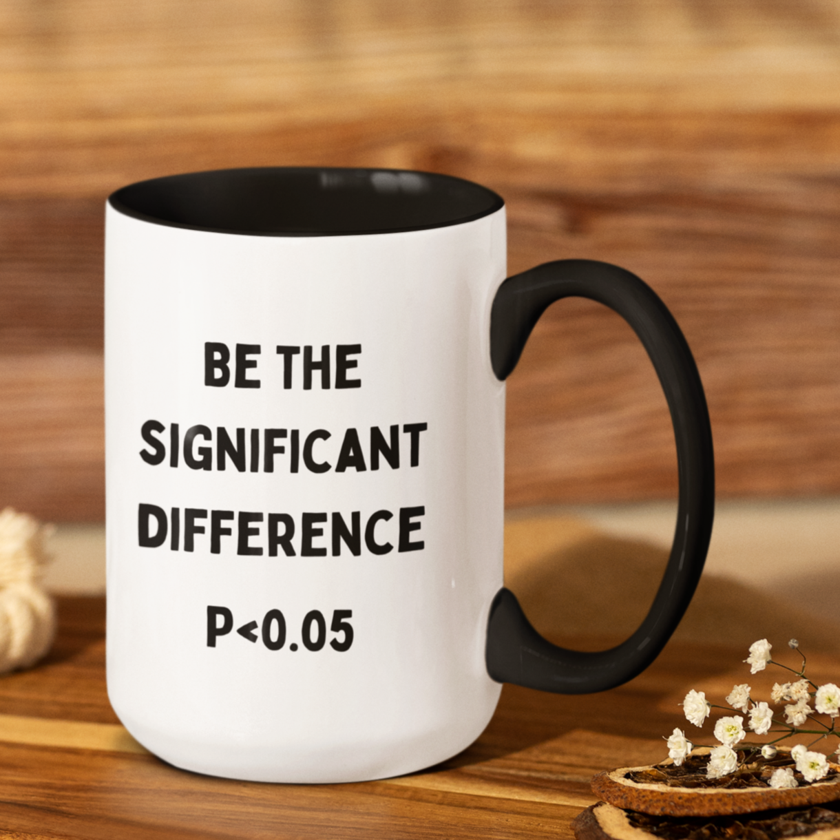 11 oz white ceramic coffee mug featuring bold black text that reads: "BE THE SIGNIFICANT DIFFERENCE P < 0.05." The handle and interior are a sleek matte black, adding a modern contrast to the bright white exterior. Ideal as a gift for academics or to add a bit of nerdy humor to your morning coffee routine!