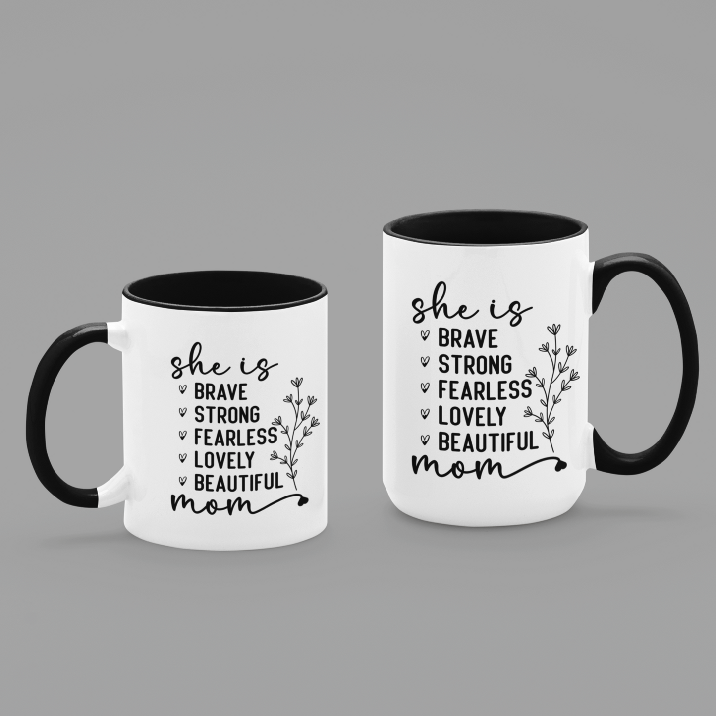 11 & 15 oz white ceramic mug with a black interior and handle. The mug features the black text 'she is BRAVE STRONG FEARLESS LOVELY BEAUTIFUL mom' stacked vertically in a handwritten-style font, accompanied by a delicate floral illustration.