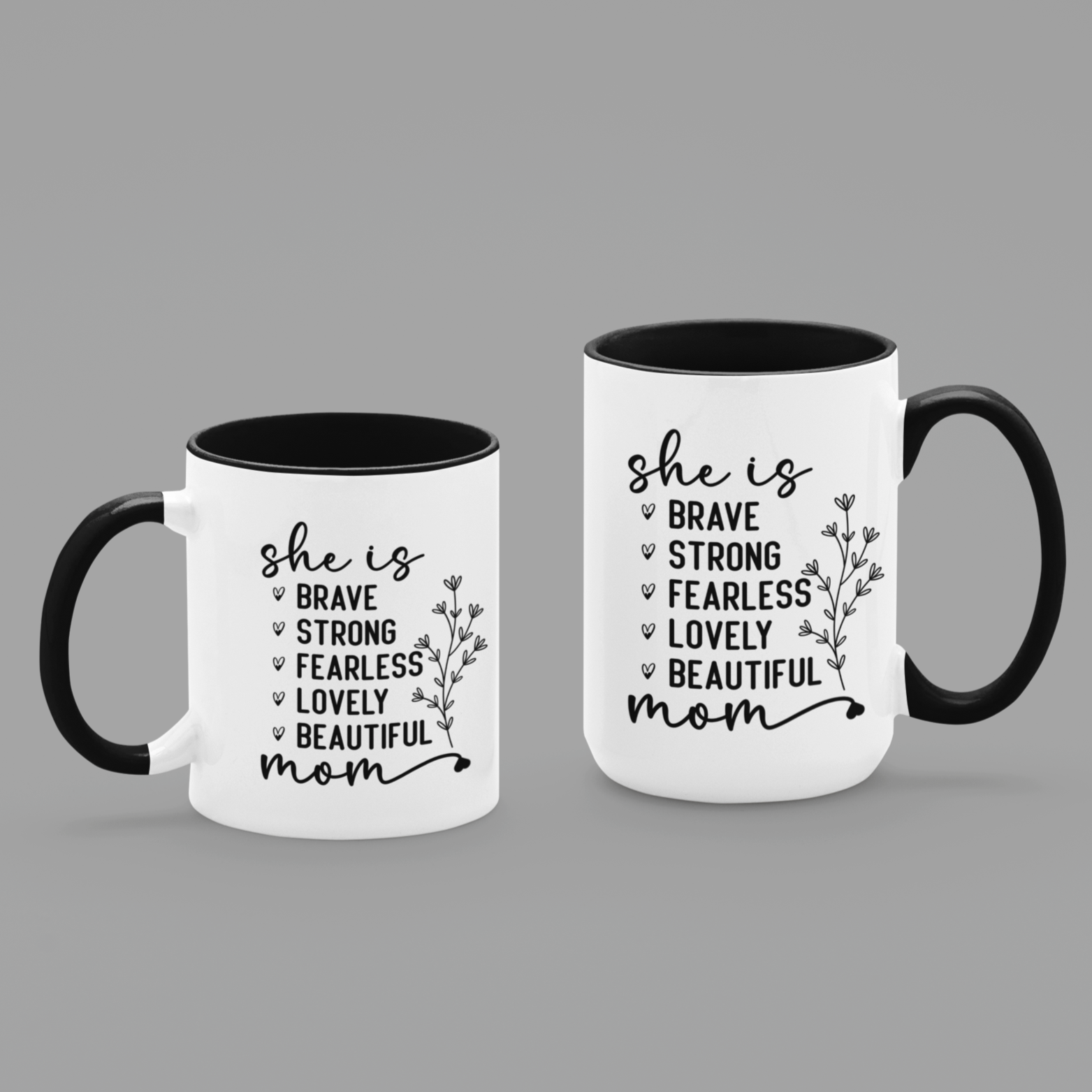 11 & 15 oz white ceramic mug with a black interior and handle. The mug features the black text 'she is BRAVE STRONG FEARLESS LOVELY BEAUTIFUL mom' stacked vertically in a handwritten-style font, accompanied by a delicate floral illustration.