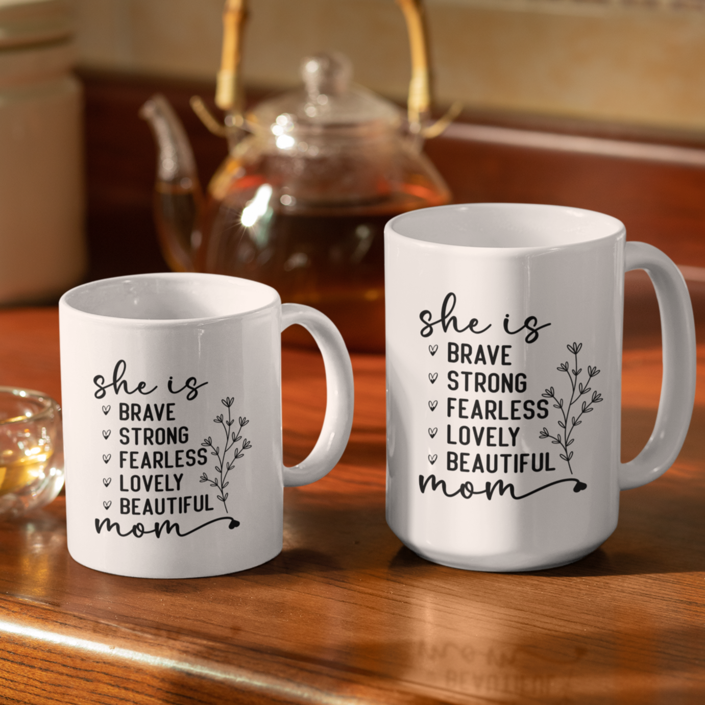11 & 15 oz white mug displaying the empowering words 'she is BRAVE STRONG FEARLESS LOVELY BEAUTIFUL mom' in an elegant black font with a floral accent. A thoughtful gift for a mom.