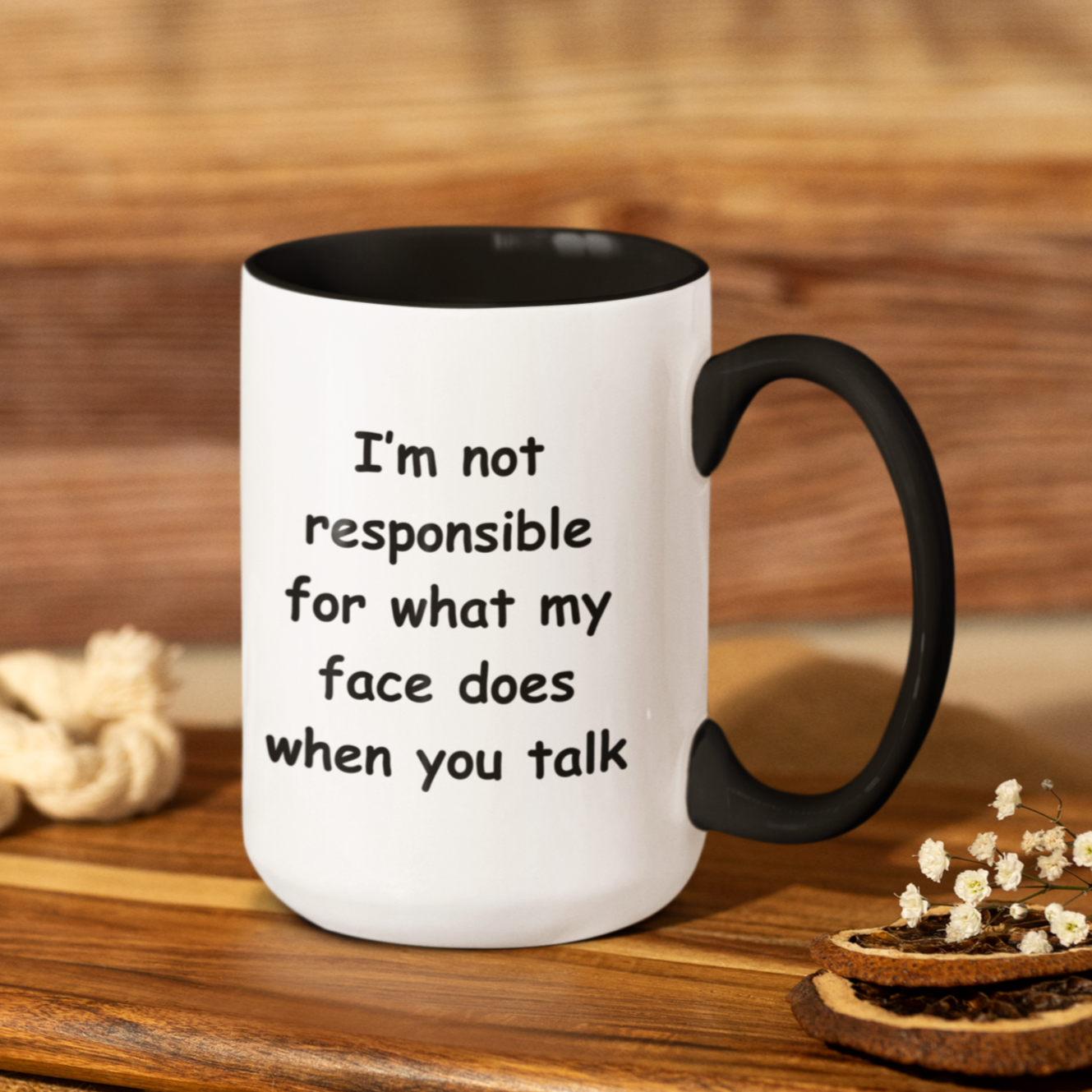 A white ceramic coffee mug with a black handle and black interior, designed for a modern and humorous touch. The mug features a bold, playful black font that reads: "I'm not responsible for what my face does when you talk." Perfect for those with a witty sense of humor, this 15oz mug makes a fun gift for coworkers, friends, or anyone who appreciates sarcasm. The high-quality print ensures the text remains sharp and vibrant, making it a standout addition to any kitchen or office space.