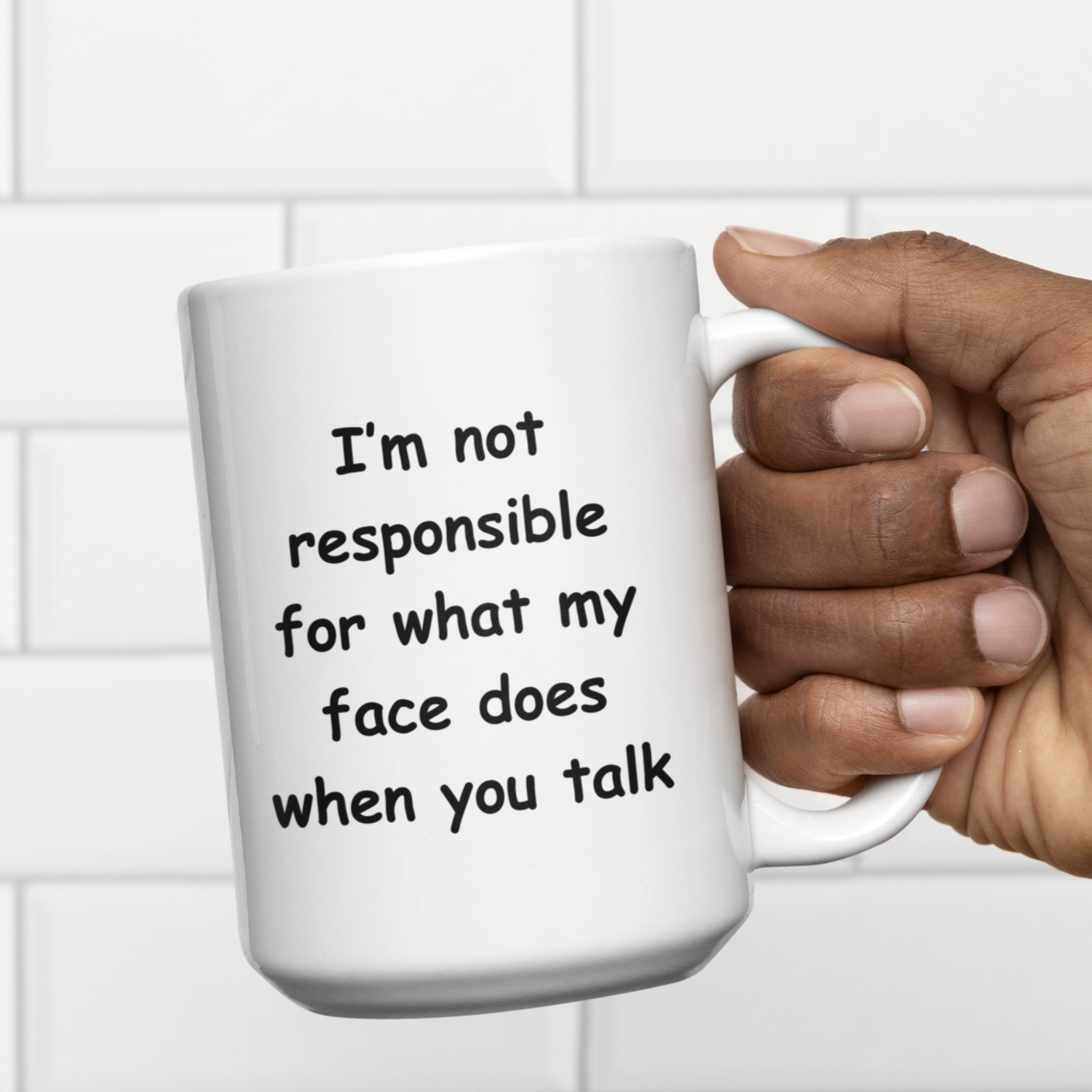 White 11 oz ceramic coffee mug featuring a humorous, bold black text that reads: "I'm not responsible for what my face does when you talk." The playful font and light-hearted message make this mug a perfect gift for coworkers, friends, or anyone with a sarcastic sense of humor. Ideal for sipping coffee, tea, or any beverage, this sturdy mug has a comfortable C-shaped handle.  Great for office desks, home kitchens, or as a funny conversation starter!