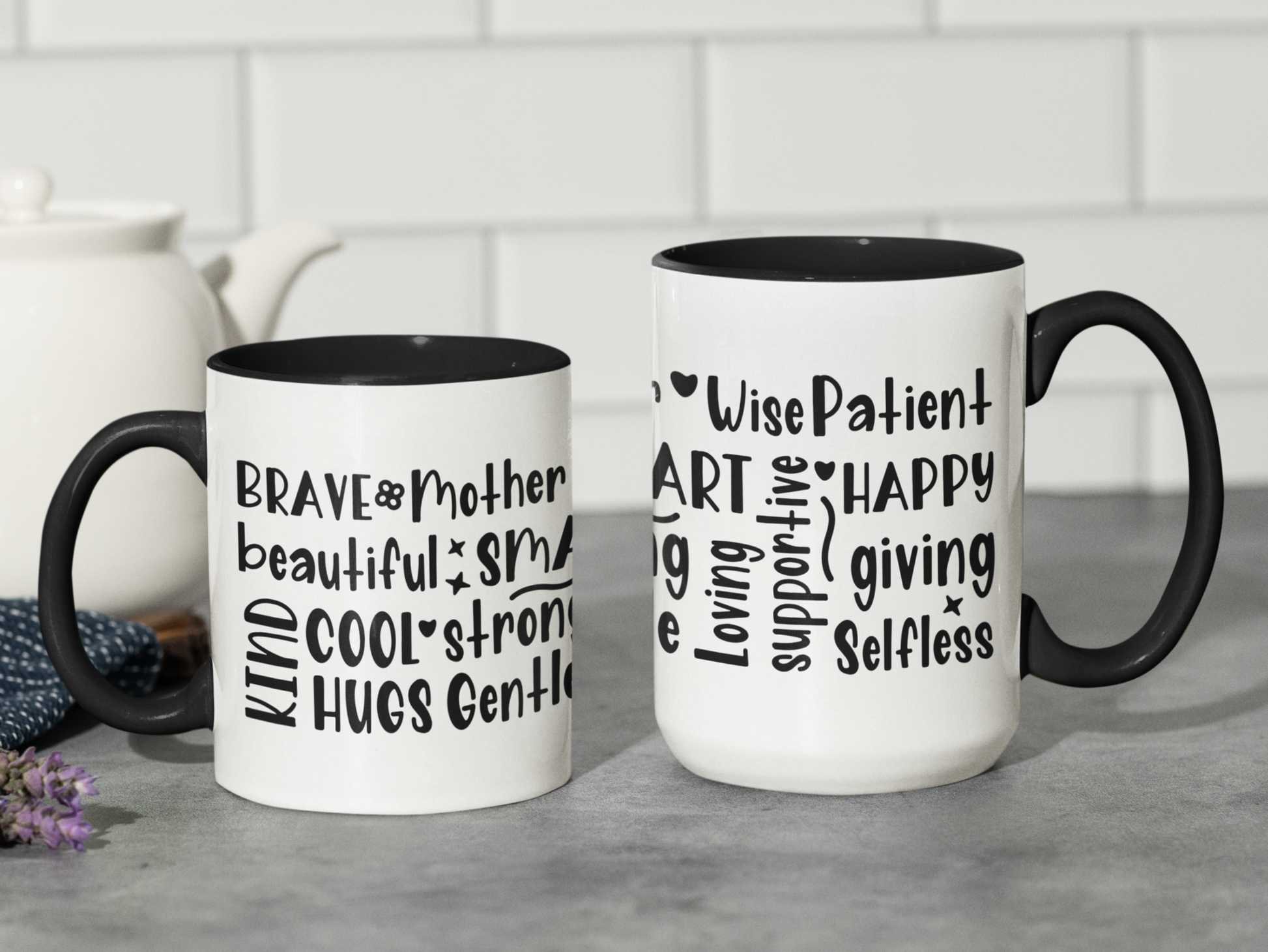 Elegant white ceramic mug with a black handle and black interior, featuring a bold, black hand-lettered word cloud celebrating motherhood. Words like “Wise,” “Patient,” “Happy,” “Giving,” “Selfless,” “Supportive,” and “Loving” wrap around the mug in playful, artistic fonts.  Perfect gift for Mother’s Day, birthdays, or to honor the strength and love of any mom.